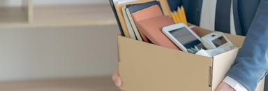 person holding box of office supplies