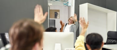 person waving goodbye to colleagues