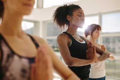 person taking a yoga class and looking serene