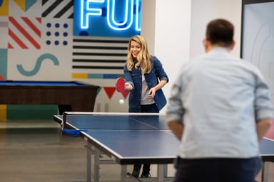 office workers playing ping pong