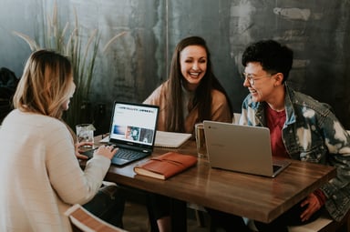 three people working and laughing