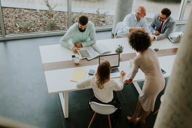 Three coworkers meeting to build a business case for an HR system