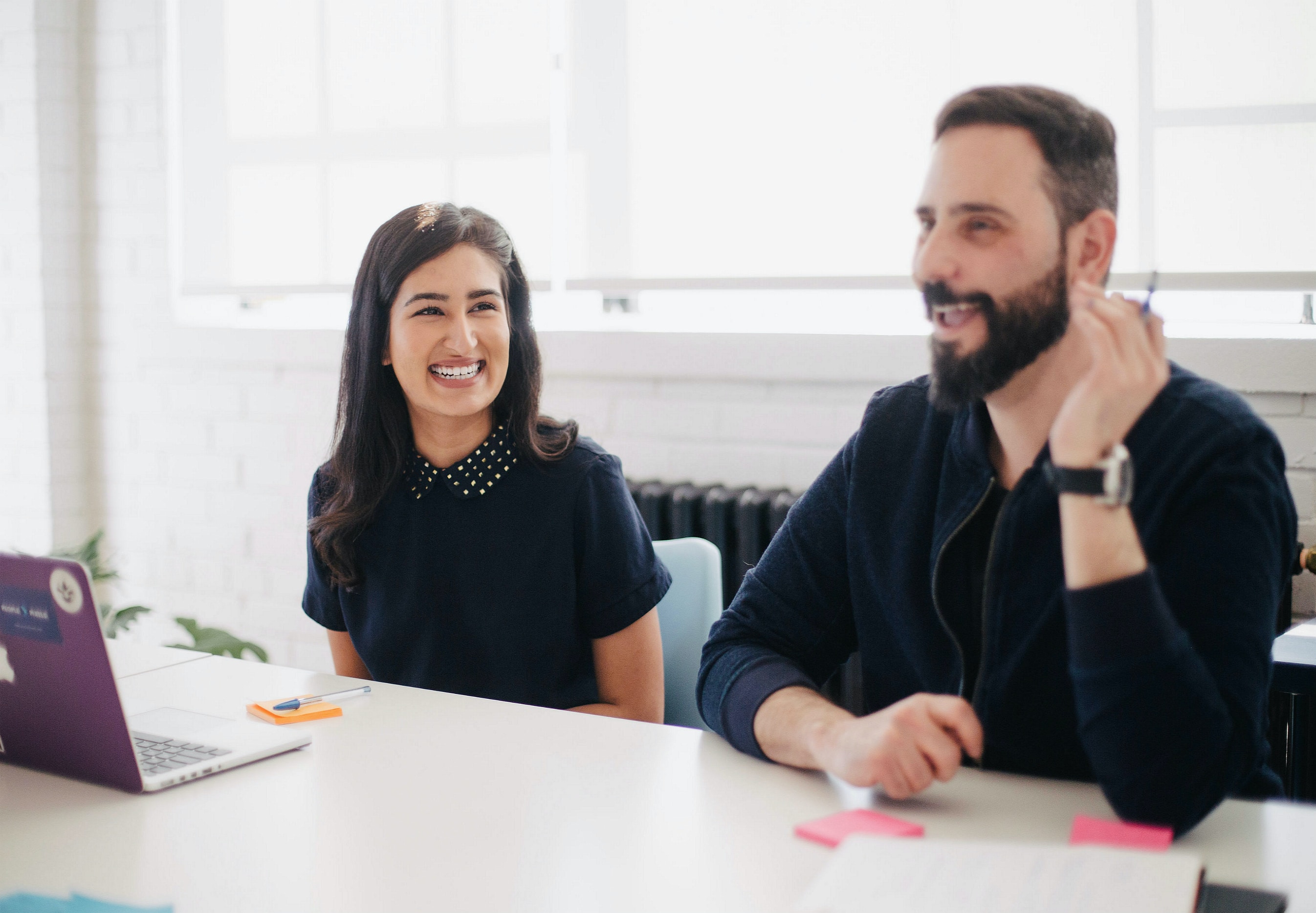 two people chatting during a meeting