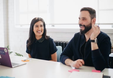 office colleagues laughing in a meeting